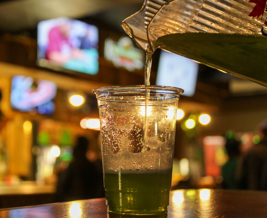 Green beer in a plastic glass. 